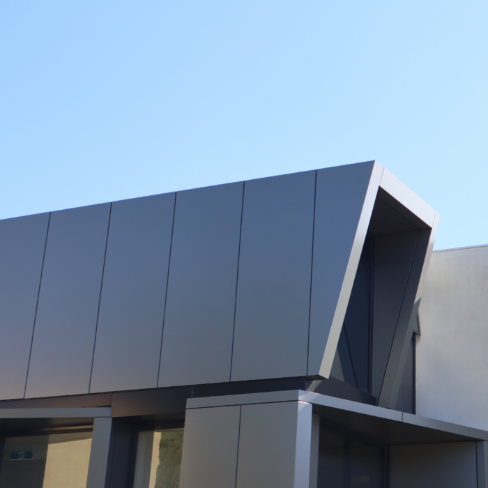 external facade cladding in dark grey metallic on a low rise building