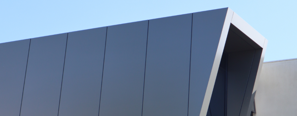 external facade cladding in dark grey metallic on a low rise building